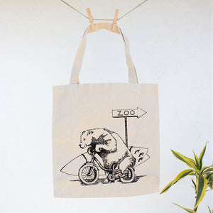 Bear with Surfboard Riding on Bike Canvas Tote